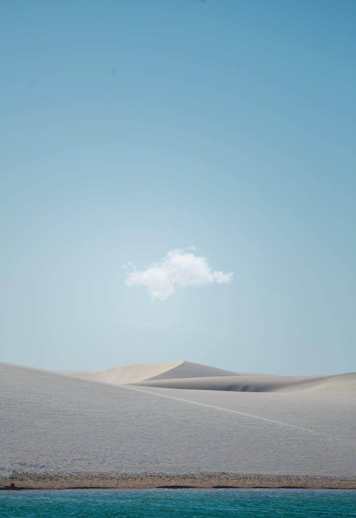 Home Serene desert dunes under a clear sky with a single cloud, perfect for mobile wallpaper.